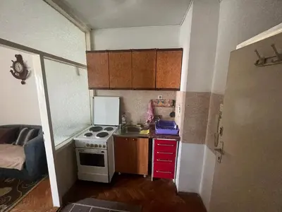 a small kitchen with a stove and a sink at A-D free wi-fi internet, air conditioner,free parking in Podgorica