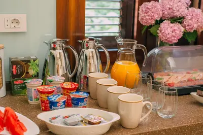 a kitchen counter with two pitchers of orange juice at Filip Deluxe Rooms in Kotor