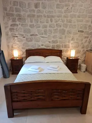 a bedroom with a bed with two towels on it at Filip Deluxe Rooms in Kotor