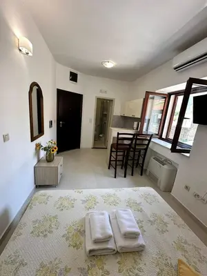 a living room with two white towels on a rug at Filip Deluxe Rooms in Kotor