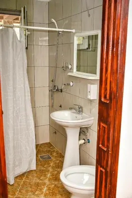 a bathroom with a sink and a toilet and a mirror at Studios Kalina in Budva