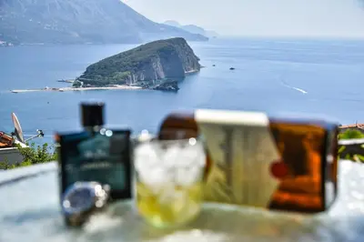 a table with a bottle of wine and a glass at Studios Kalina in Budva