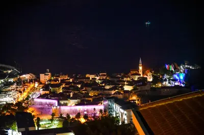 a view of a city at night with lights at Studios Kalina in Budva