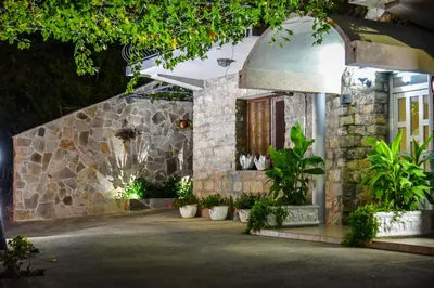 a stone building with potted plants in front of it at Studios Kalina in Budva