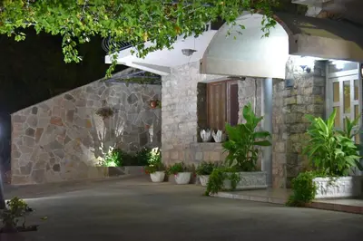 a stone house with plants in front of it at Studios Kalina in Budva