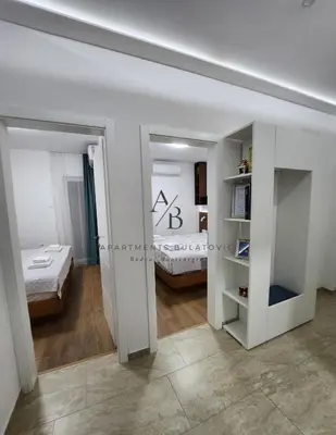 a white room with a bed and a bedroom at Apartments Bulatovic in Budva