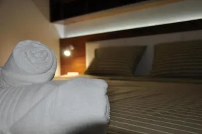 a pile of white towels sitting on a bed at Apartments Bulatovic in Budva