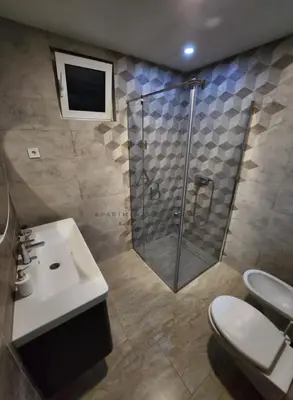 a bathroom with a shower and a sink and a toilet at Apartments Bulatovic in Budva