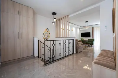 a living room with a staircase in a house at Cosy Duplex near Bus Station in Budva