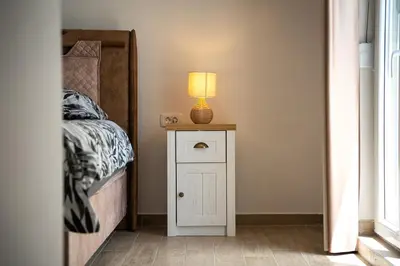 a bedroom with a bed and a lamp on a night stand at Cosy Duplex near Bus Station in Budva