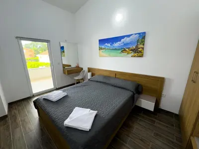 a bedroom with a bed with two towels on it at Adla Apartmani in Ulcinj