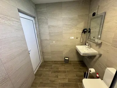 a bathroom with a sink and a mirror at Adla Apartmani in Ulcinj
