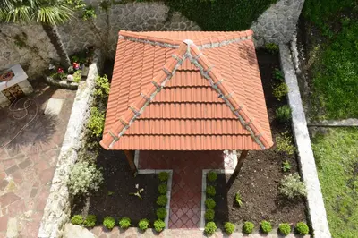 an overhead view of a house with an orange roof at Villa Andrea Apartments with parking in Kotor