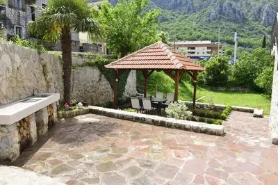 a patio with a gazebo and a table and chairs at Villa Andrea Apartments with parking in Kotor