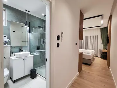 a bathroom with a shower and a toilet and a sink at AMD Premium rooms Budva in Budva