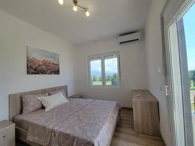a bedroom with a bed and a window at Angie's in Ulcinj