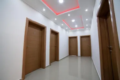 a hallway with wooden doors and a skylight at L&I Villa in Ulcinj