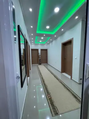 an empty hallway with green lights on the ceiling at L&I Villa in Ulcinj