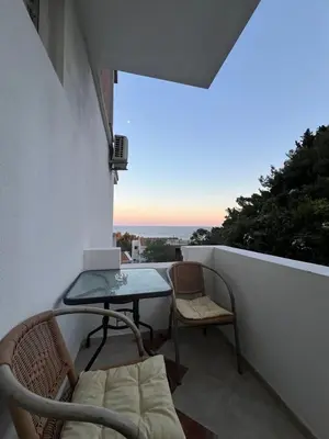 a balcony with a table and chairs on a balcony at L&I Villa in Ulcinj