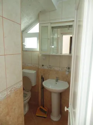 a bathroom with a sink and a toilet and a mirror at Apartments Macaso in Bar