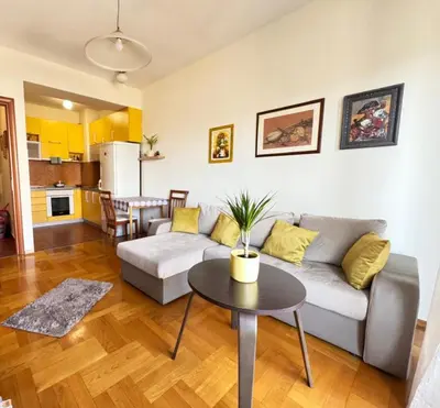 a living room with a couch and a table at Sunny place in Podgorica