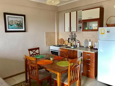 a kitchen with a table and a white refrigerator at Grlica in Bar