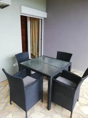 a dining room table and chairs with a glass table and chairs at Grlica in Bar