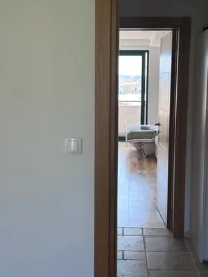 a hallway with a door leading to a room at Apartman Andrea in Bar