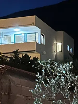a house with a blue light in front of it at Apartman Andrea in Bar