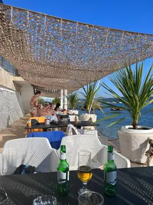 a table with two bottles of wine on top of a patio at Apartman Andrea in Bar