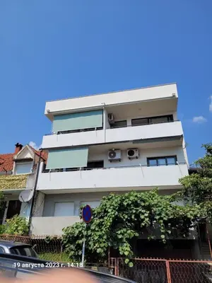 a tall white building with plants on it at Apartman Andrea in Bar