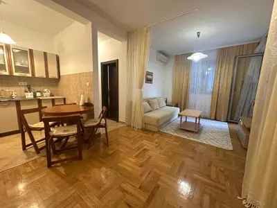 a living room with a table and a dining room at Apartment Caramel Petrovac in Petrovac na Moru