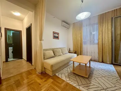 a living room with a couch and a table at Apartment Caramel Petrovac in Petrovac na Moru