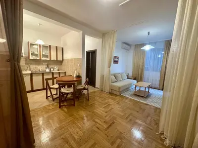 a kitchen and living room with a table and a couch at Apartment Caramel Petrovac in Petrovac na Moru