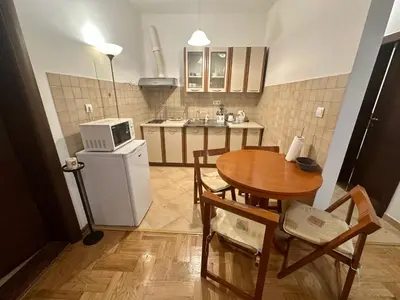 a small kitchen with a table and a microwave at Apartment Caramel Petrovac in Petrovac na Moru