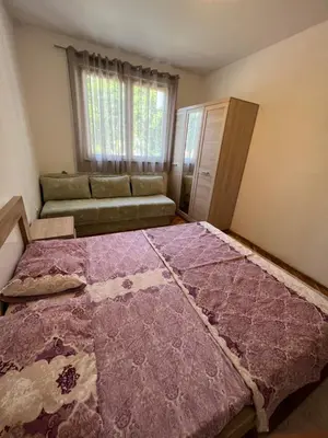 a bedroom with a large bed and a couch at Sutomore Centar in Sutomore