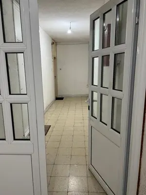 an empty hallway with a door and a tile floor at Sutomore Centar in Sutomore