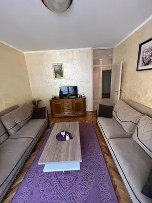 a living room with two couches and a coffee table at Sutomore Centar in Sutomore