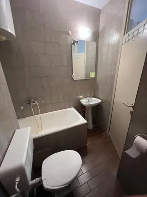 a bathroom with a tub and a toilet and a sink at Sutomore Centar in Sutomore