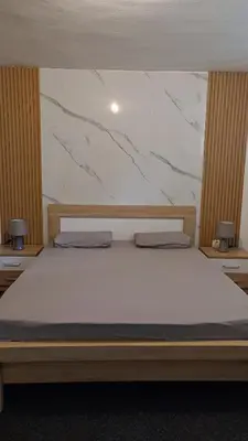 a bed with two pillows on it in a bedroom at V&J apartments in Podgorica