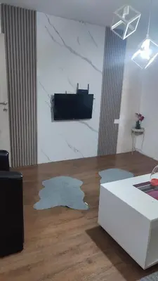 a living room with a white couch and a table at V&J apartments in Podgorica