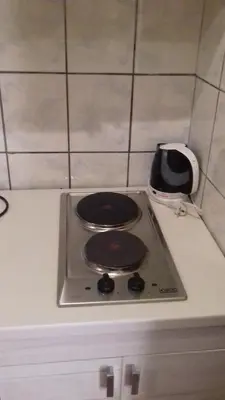a stove top oven sitting on top of a kitchen counter at V&J apartments in Podgorica