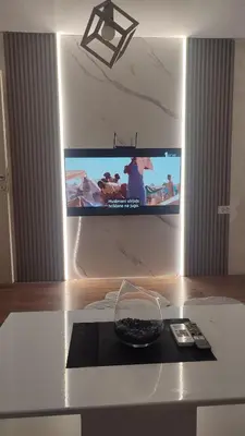 a television on a wall with a bowl on a table at V&J apartments in Podgorica