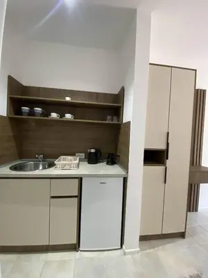a kitchen with white cabinets and a sink at Casa Gazi in Ulcinj