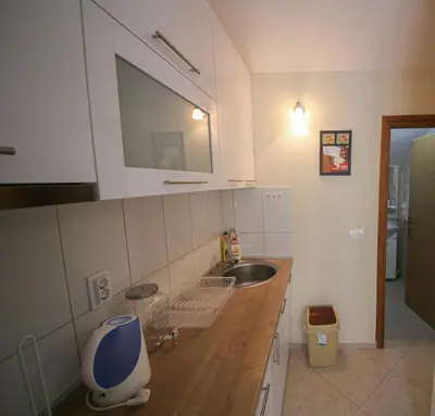 a small kitchen with a sink and a mirror at Goga Apartment in Kotor