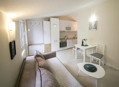 a living room with a couch and a table at Goga Apartment in Kotor