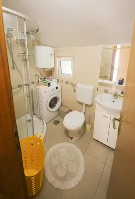 a small bathroom with a toilet and a sink at Goga Apartment in Kotor
