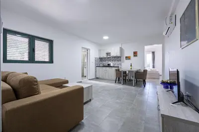 a living room with a couch and a dining room at Petrovac Holiday Apartments 2 in Petrovac na Moru