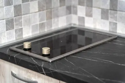 a glass counter top with two cups on top of it at Petrovac Holiday Apartments 2 in Petrovac na Moru
