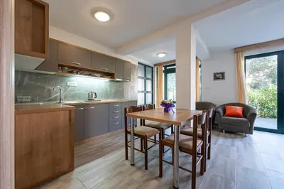 a kitchen and dining room with a table and chairs at Petrovac Holiday Apartments 2 in Petrovac na Moru